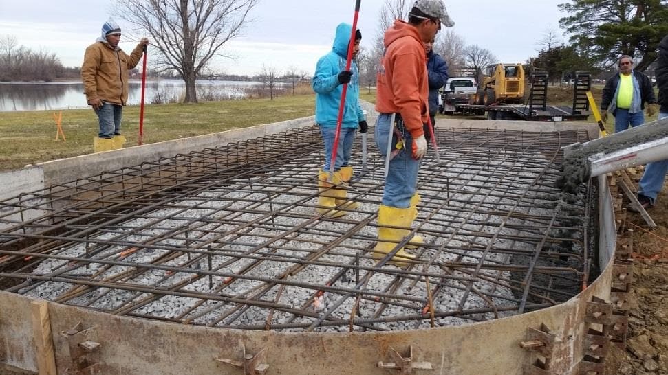 Pouring concrete for the memorial foundation